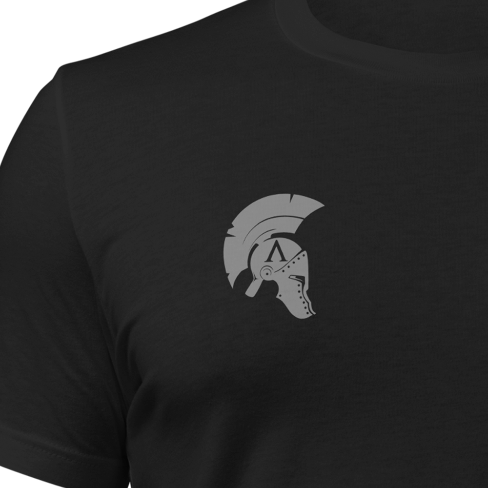 Close up of front chest of Black short sleeve unisex fit original cotton T-Shirt by Achilles Tactical Clothing Brand printed with This flag we defend design across back