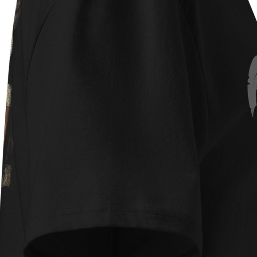 Black T-shirt sleeve detail on a plain background