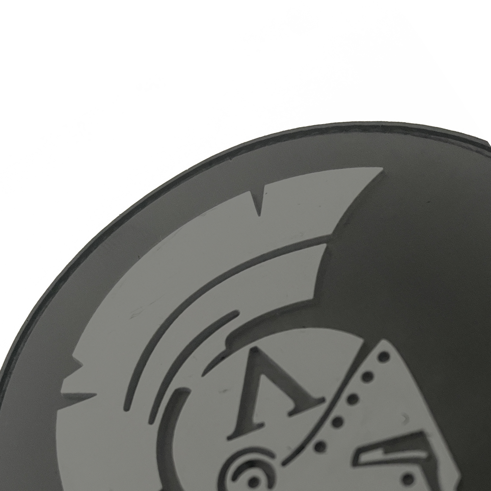 Black PVC 3D Achilles patch with with a grey Achilles Spartan helmet design on a white background