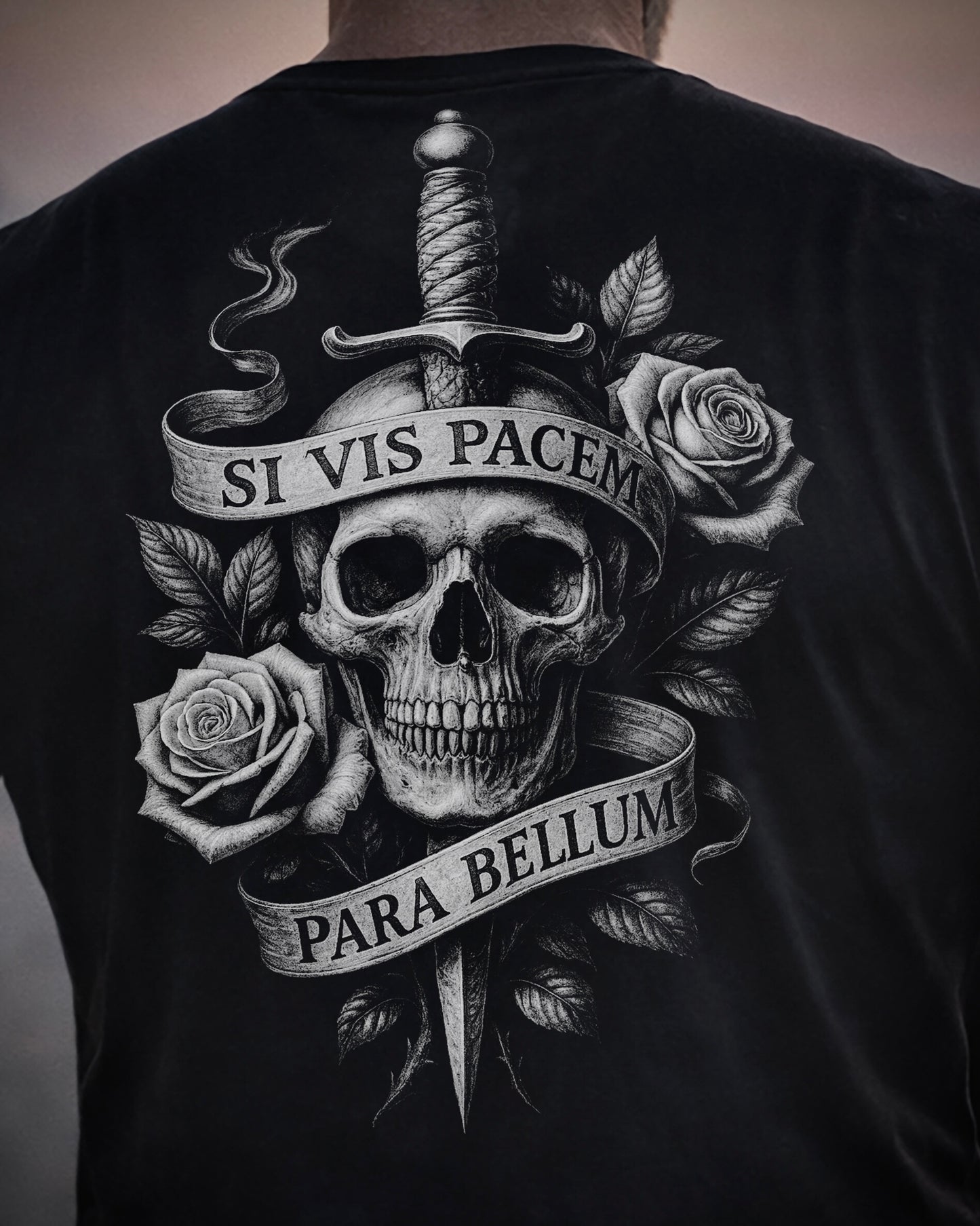 Close up of back view of man wearing black Achilles T-shirt printed with Si vis pacem para bellum on back
