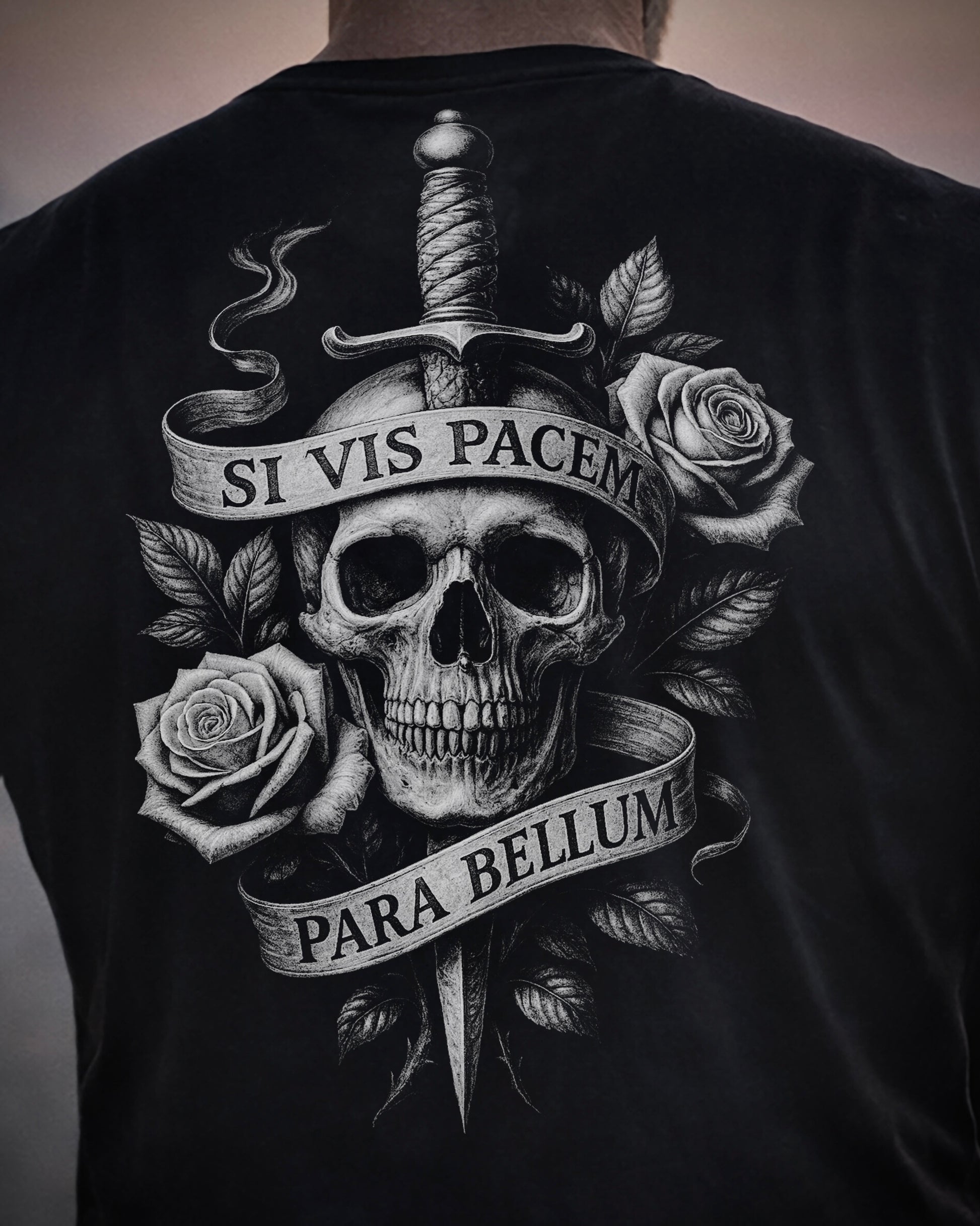 Close up of back view of man wearing black Achilles T-shirt printed with Si vis pacem para bellum on back
