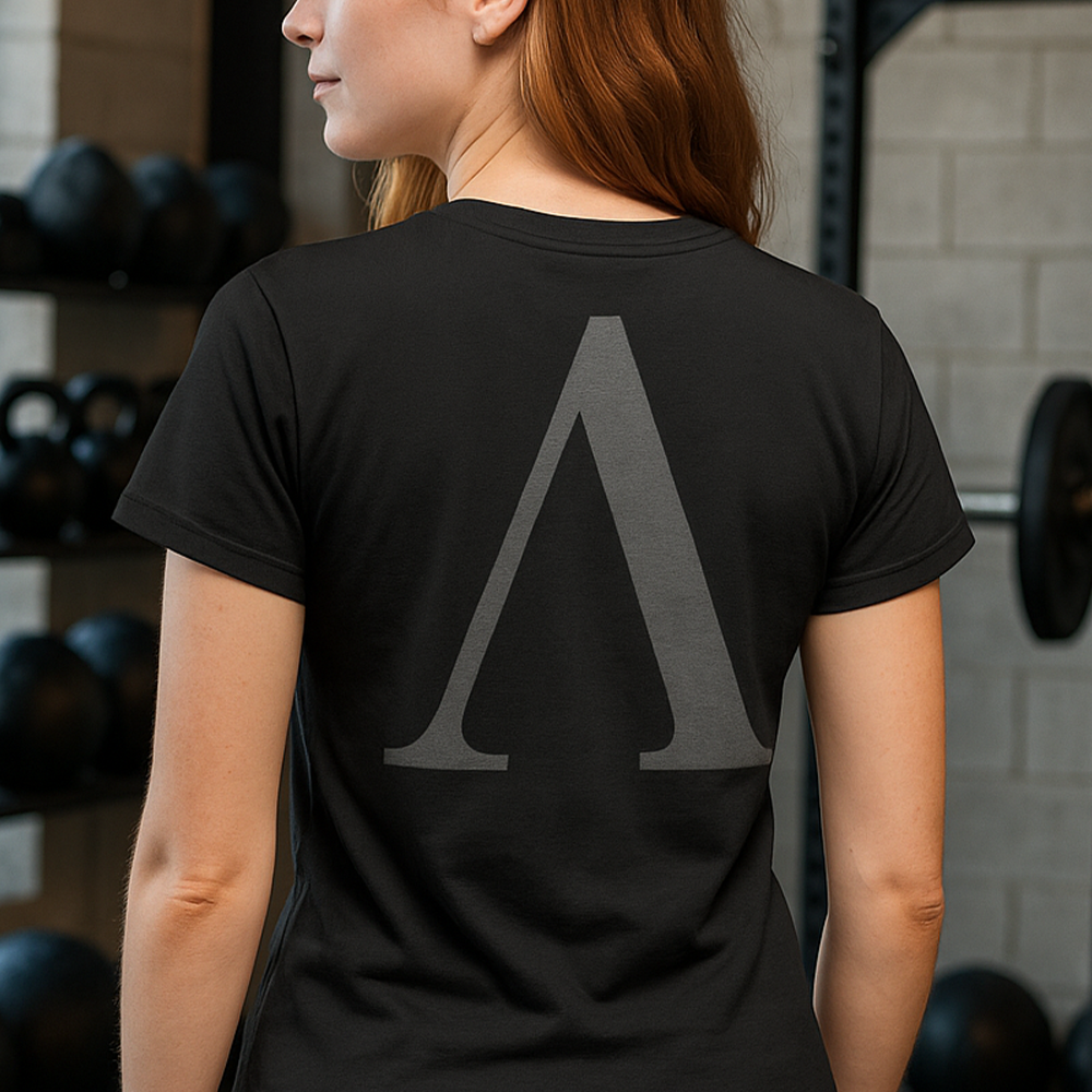 Back view of woman wearing Black short sleeve unisex fit original cotton T-Shirt by Achilles Tactical Clothing Brand printed with A Brand design across back
