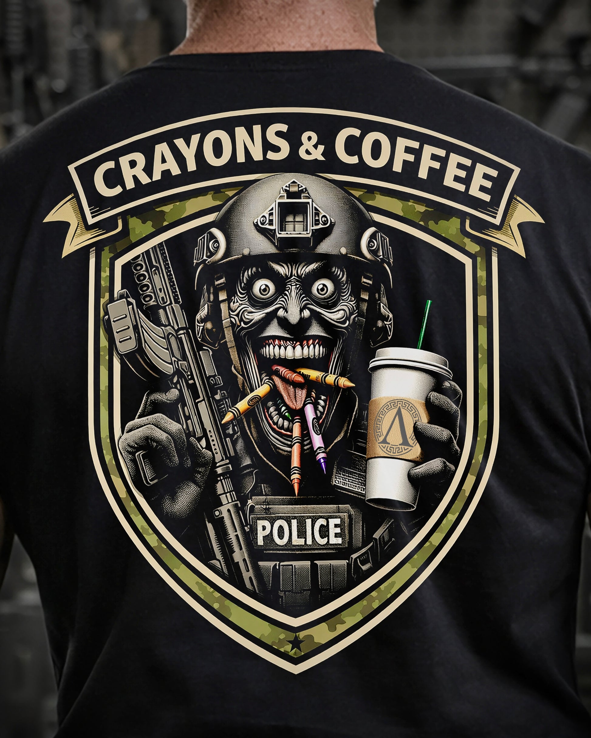 Close up of back view of man wearing black Achilles T-shirt printed with Crayons and Coffee logo on back