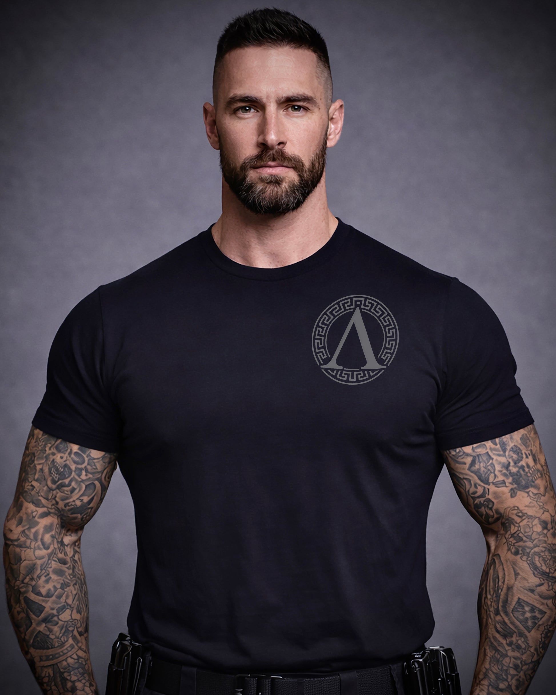 Front view of man wearing black Achilles T-shirt printed with Roundel logo on front chest
