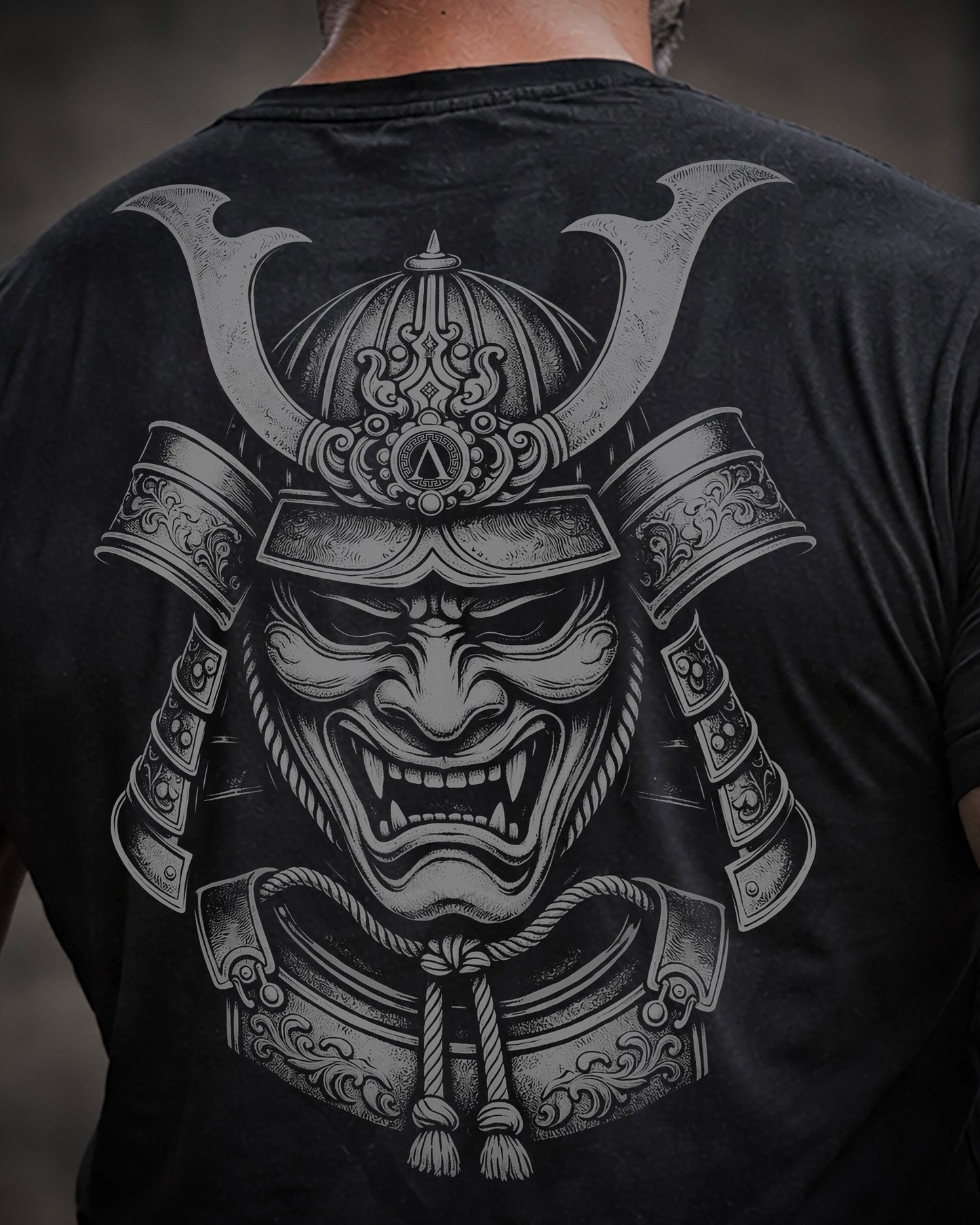 Close up of back view of man wearing black Achilles T-shirt printed with large Ronin logo on back