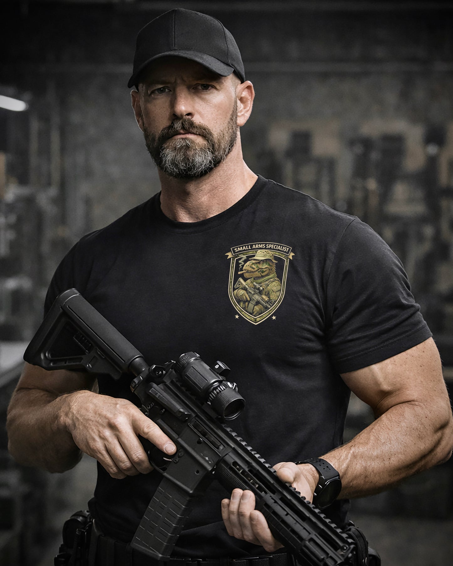 Front view of man wearing black Achilles T-shirt printed with Small Arms Specialist  logo on chest