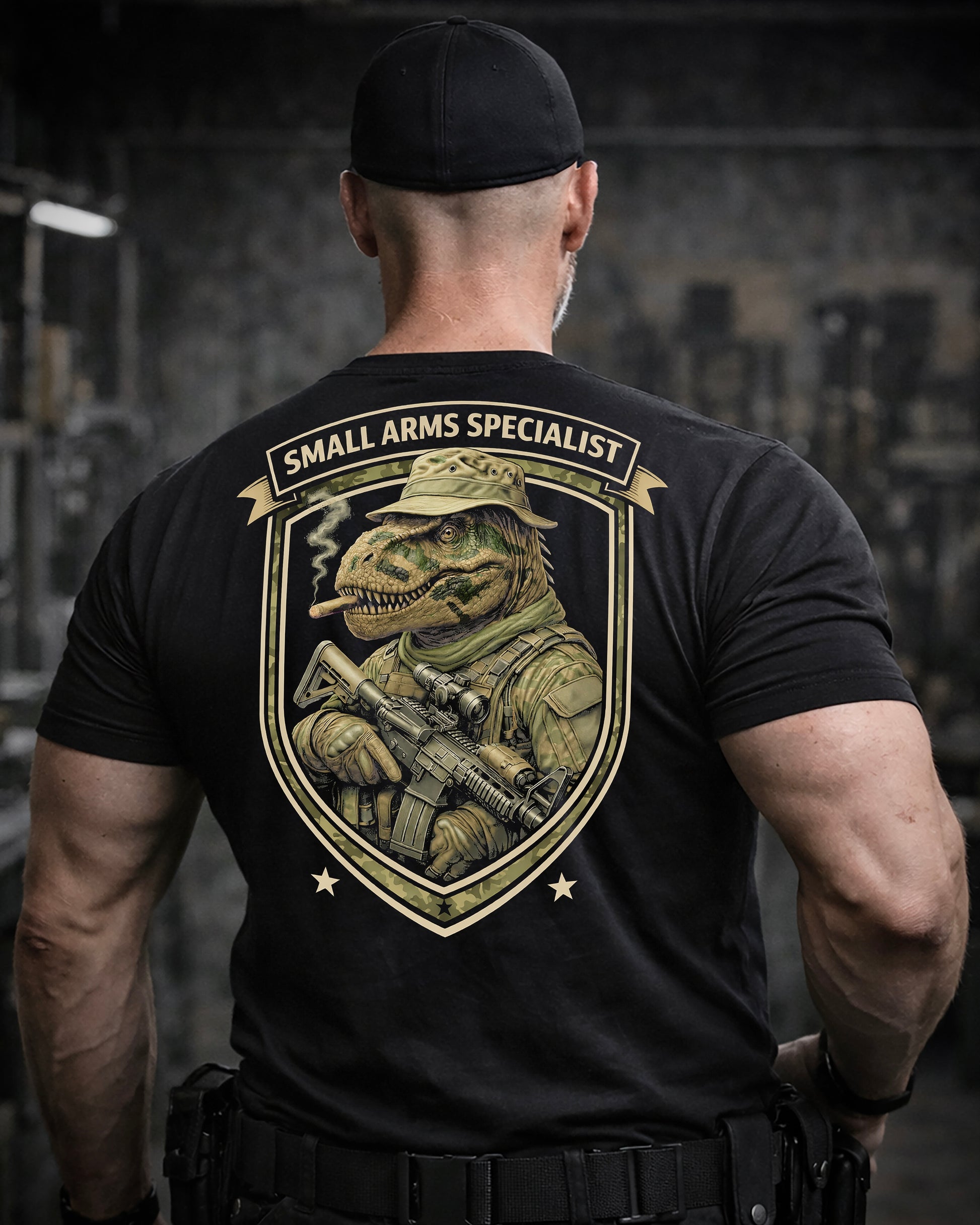Back view of man wearing black Achilles T-shirt printed with Small Arms Specialist  logo on back