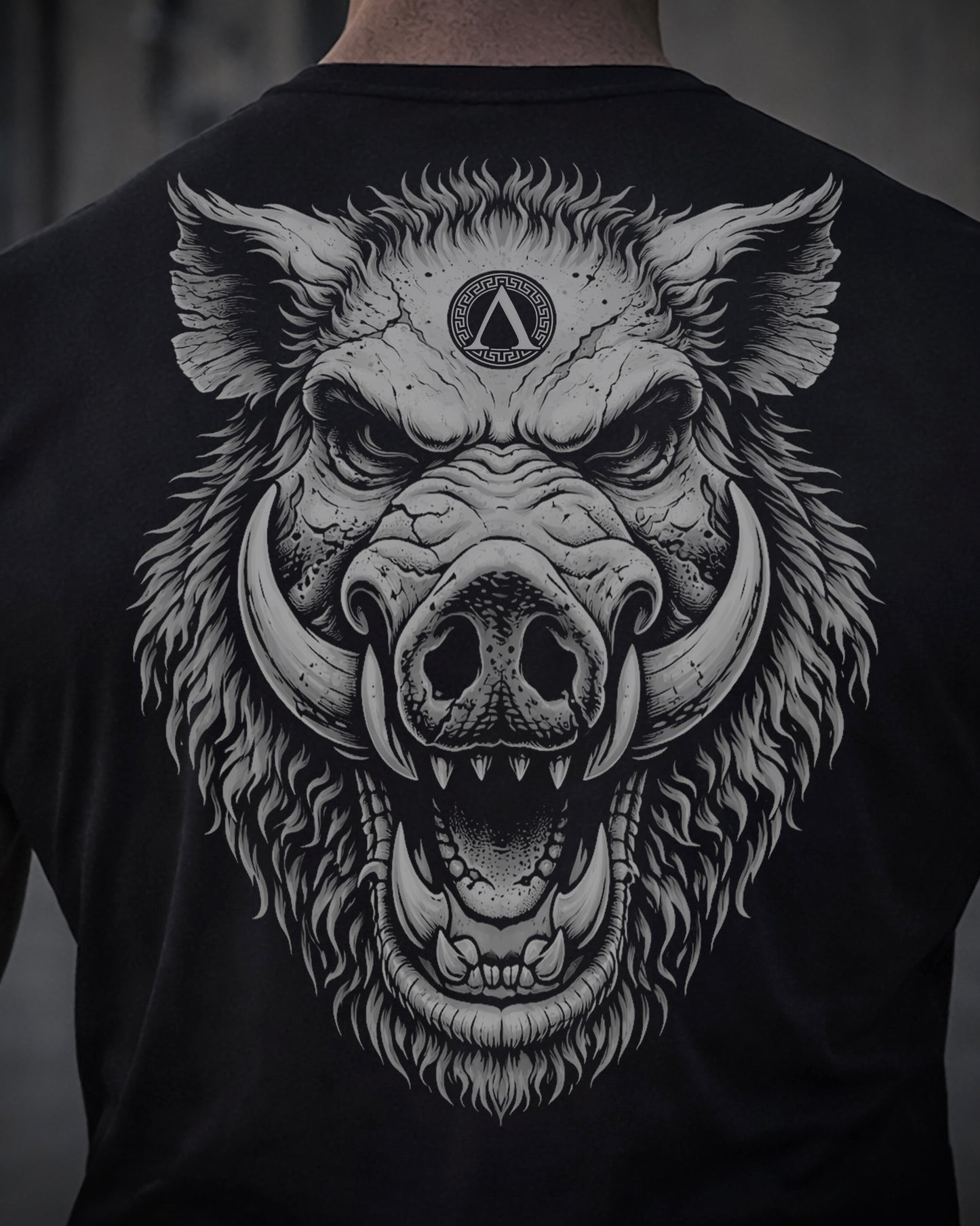 Close up of back view of man wearing black Achilles T-shirt printed with large Wild Boar logo on back