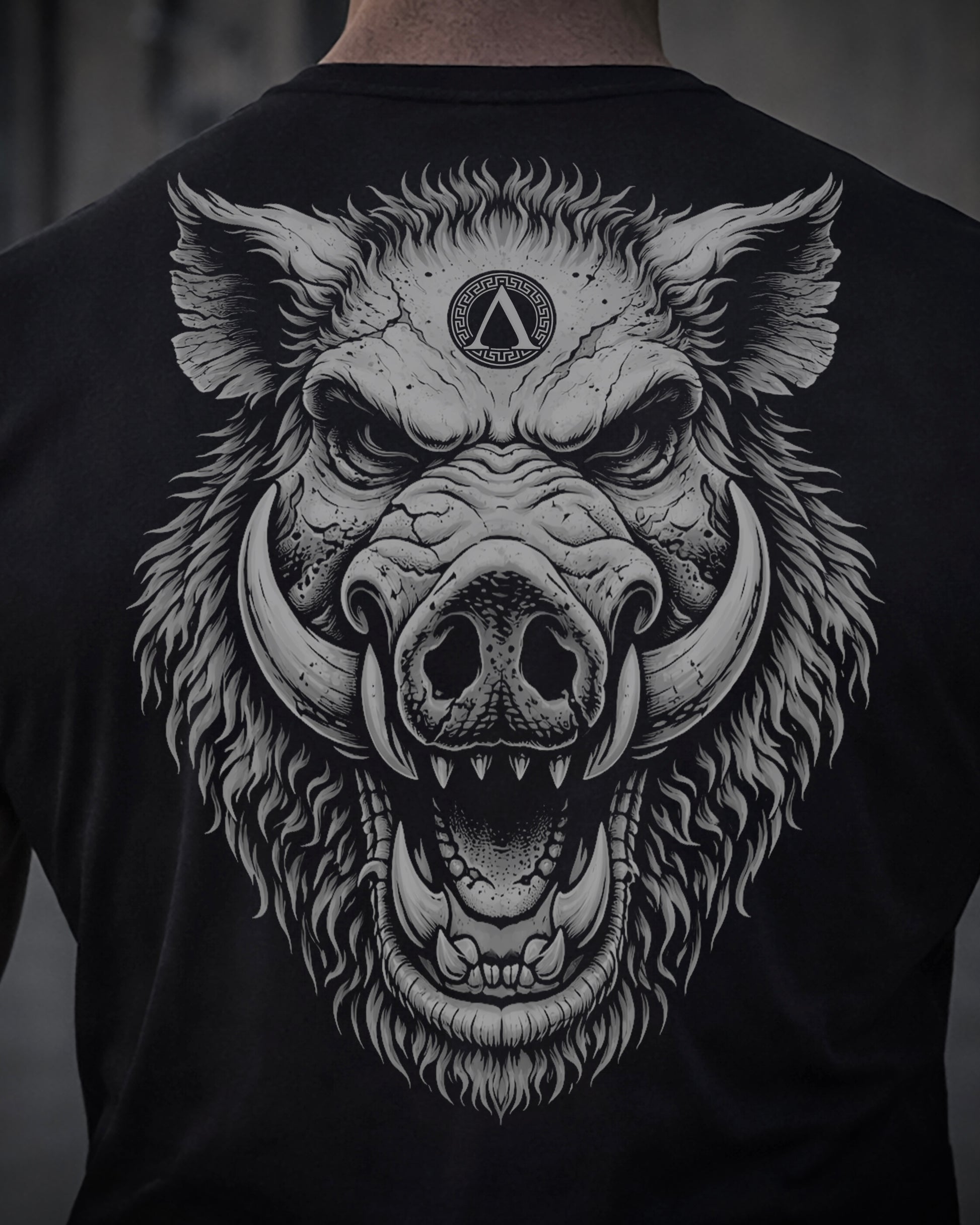 Close up of back view of man wearing black Achilles T-shirt printed with large Wild Boar logo on back