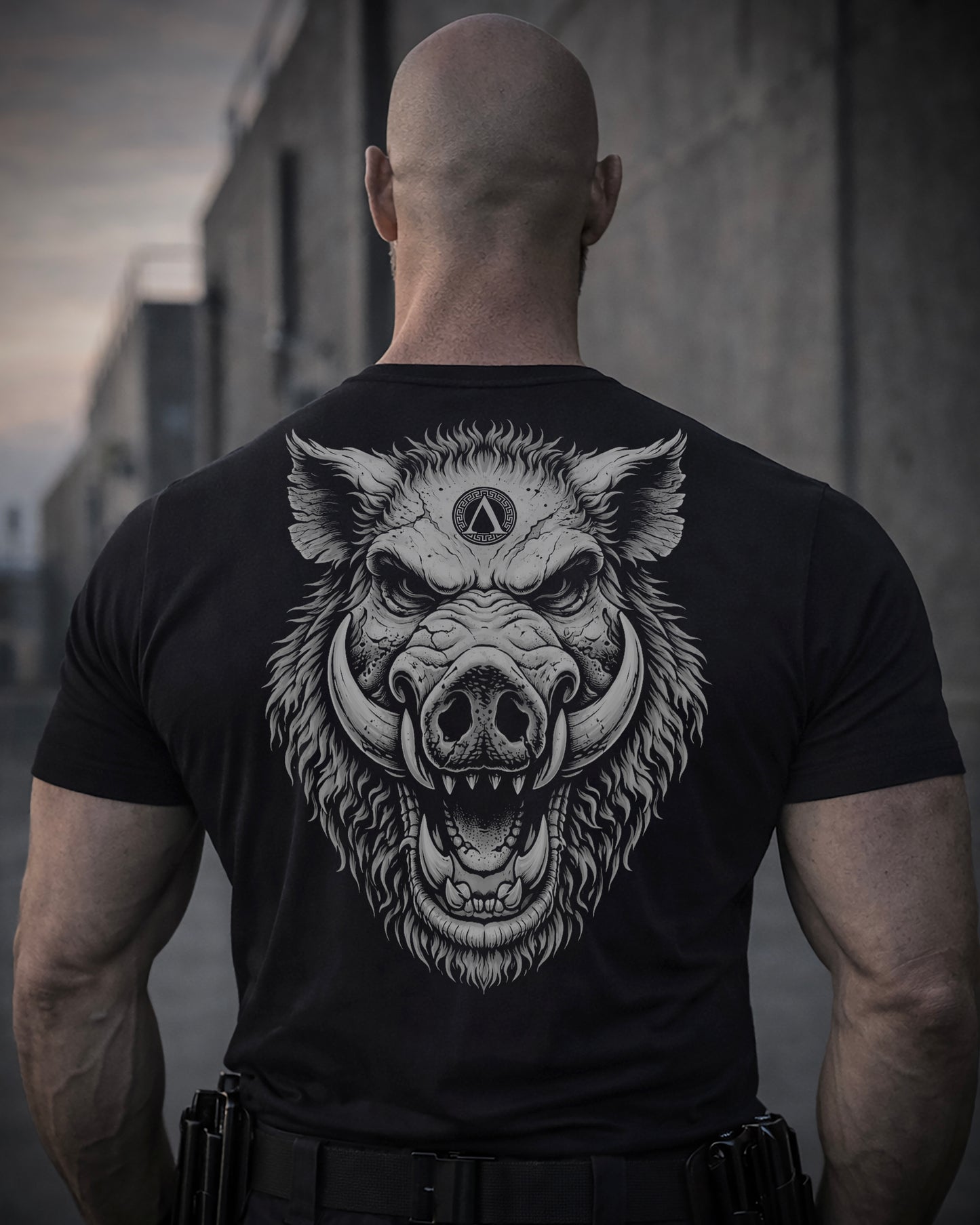 Back view of man wearing black Achilles T-shirt printed with large Wild Boar logo on back